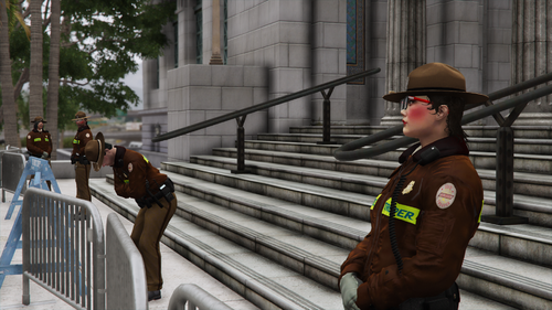 Could contain: clothing, person, outdoor, fence, man, tree, human face, stairs, building, hat, wearing, street