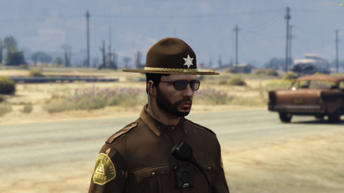 Could contain: outdoor, sky, clothing, person, vehicle, land vehicle, man, human face, hat, law enforcement, wheel, car, fashion accessory, security, wearing, officer, military uniform