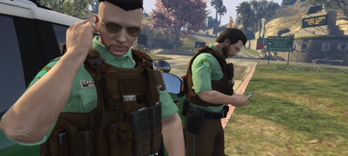 Could contain: clothing, person, human face, tree, outdoor, grass, man, hiking, vest