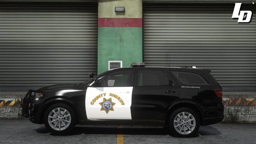 Could contain: vehicle, land vehicle, wheel, tire, text, building, law enforcement, outdoor, auto part, police car, automotive exterior, vehicle registration plate, street, car, police