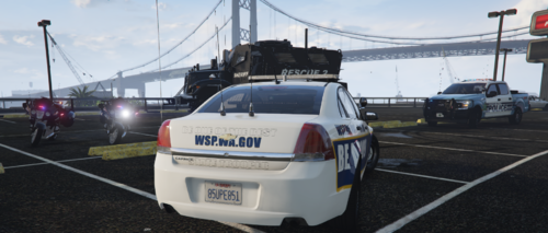 Could contain: text, vehicle, outdoor, land vehicle, sky, wheel, vehicle registration plate, road, tire, automotive exterior, automotive tail & brake light, auto part, motor vehicle, ground, police, car