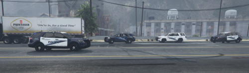 Could contain: wheel, vehicle, road, outdoor, land vehicle, tire, building, text, auto part, motor vehicle, street, transport, mode of transport, asphalt, automotive tire, automotive design, police, car, driving, officer, city