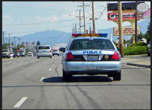 Could contain: vehicle, land vehicle, text, outdoor, sky, wheel, road, vehicle registration plate, transport, police, police car, full-size car, automotive exterior, family car, automotive tail & brake light, street, car
