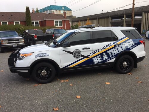 Could contain: vehicle, land vehicle, wheel, tire, outdoor, transport, text, motor vehicle, police, auto part, automotive exterior, bumper, road, fender, car, parked, street