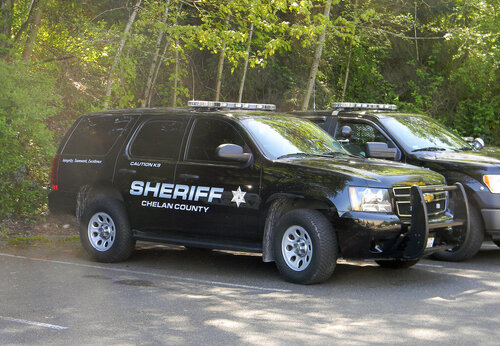 Could contain: vehicle, tire, wheel, land vehicle, outdoor, tree, transport, auto part, sport utility vehicle, bumper, text, compact sport utility vehicle, automotive exterior, ford, motor vehicle, automotive tire, car, fender, roof rack, crossover suv, road, parked, police, suv