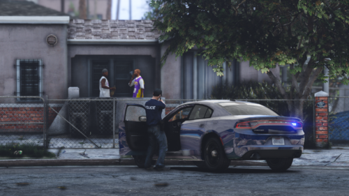 Could contain: outdoor, vehicle, land vehicle, building, wheel, tree, road, mid-size car, sports sedan, person, clothing, full-size car, transport, automotive design, car, ground, street, police