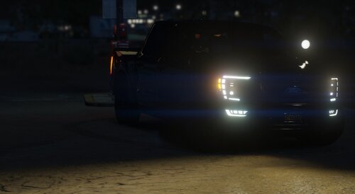 Could contain: vehicle, land vehicle, outdoor, ground, road, car, tire, automotive exterior, light, street, night