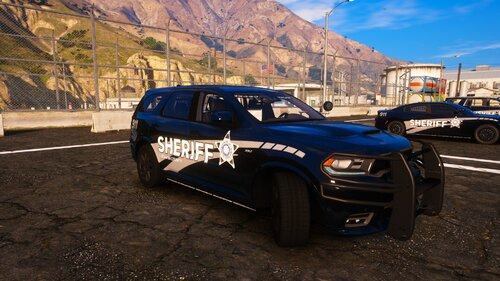 Could contain: vehicle, outdoor, land vehicle, tire, wheel, sky, ground, auto part, bumper, mountain, road, parked, car