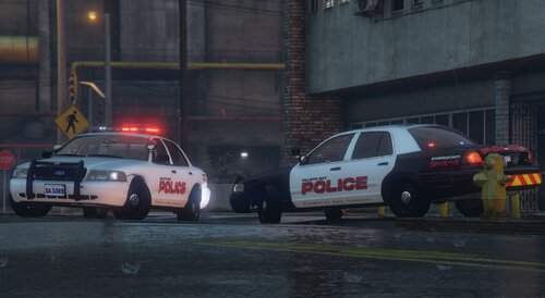 Could contain: vehicle, land vehicle, wheel, outdoor, tire, building, transport, text, road, emergency service, car, auto part, police car, emergency vehicle, vehicle registration plate, law enforcement, automotive tail & brake light, ford crown victoria police interceptor, police, street