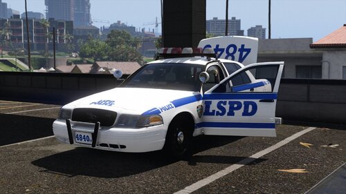 Could contain: vehicle, land vehicle, text, outdoor, wheel, police car, law enforcement, building, full-size car, transport, vehicle registration plate, road, police, car, city, street