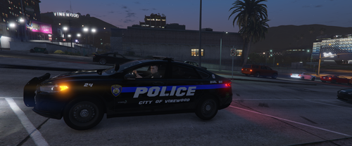 Could contain: vehicle, land vehicle, outdoor, wheel, transport, road, sky, text, tire, building, street, police car, auto part, law enforcement, city, car, night, light, police