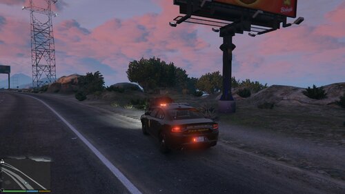 Could contain: outdoor, sky, cloud, road, land vehicle, vehicle, street, car, light, wheel, tree, traffic, ground, intersection, driving, red, sunset