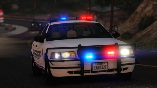 Could contain: vehicle, land vehicle, outdoor, wheel, transport, police car, law enforcement, full-size car, road, text, vehicle registration plate, automotive lighting, automotive light bulb, emergency service, auto part, ford crown victoria police interceptor, car, light, street, police