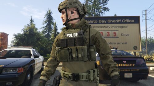 Could contain: outdoor, vehicle, land vehicle, text, sky, wheel, clothing, law enforcement, military person, road, soldier, car, tire, army, military organization, military camouflage, camouflage, infantry, person, security, organization, helmet, ballistic vest, marines, troop, military uniform, street, officer, police, military